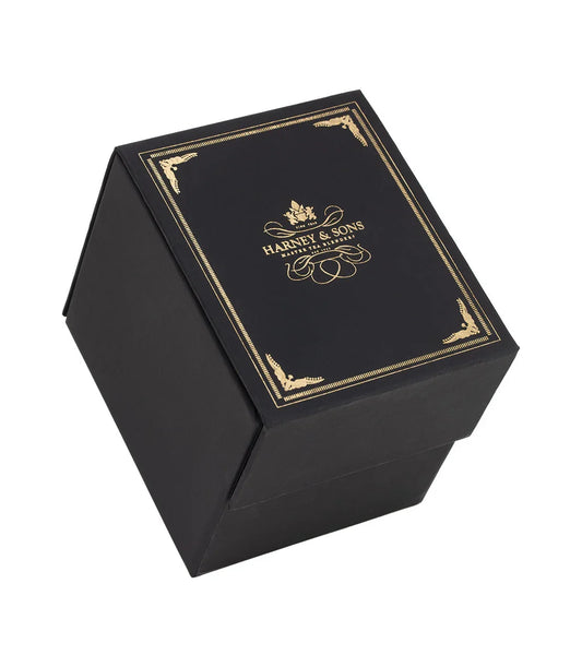 Harney & Sons black magnetic gift box with gold foil design, closed, on white background