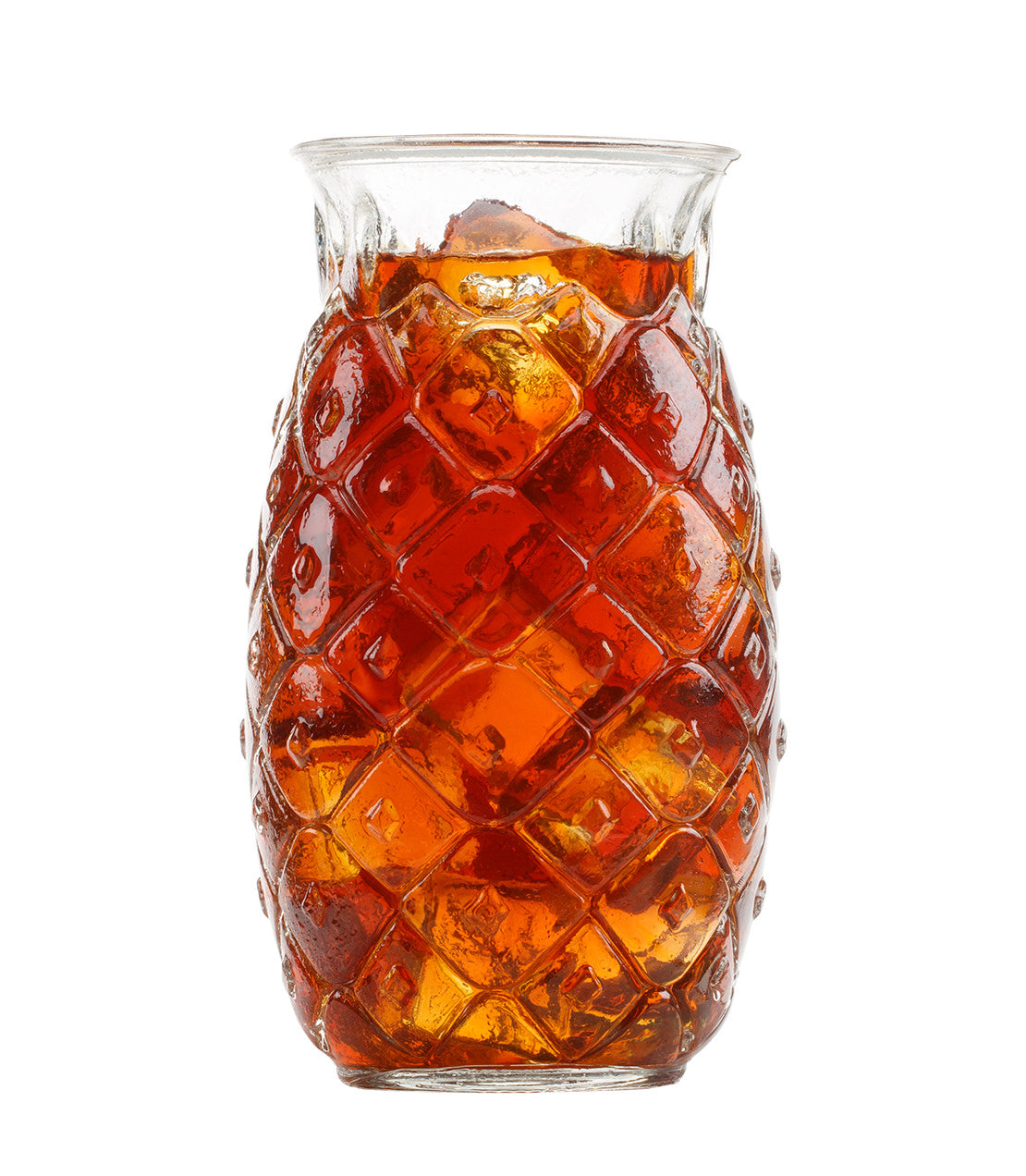 Pineapple-shaped glass filled with iced tea on a white background