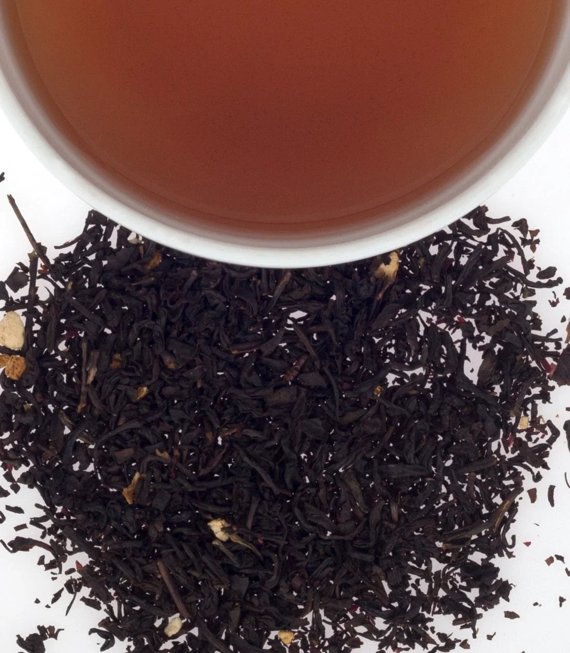 Cup of cranberry autumn tea with loose leaf blend on white background