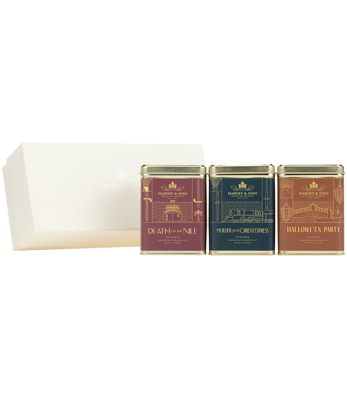 Three small tea tins with decorative labels on a white background