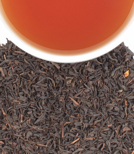 Cup of cranberry autumn tea with loose black tea leaves