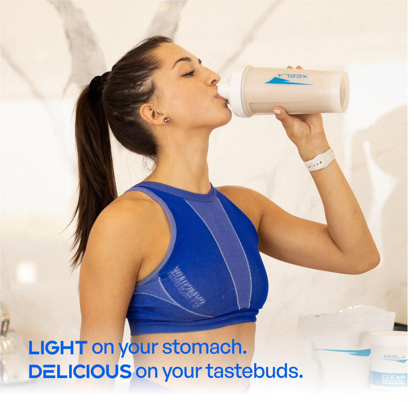 Woman in blue sports bra drinking from a protein shake container with text about its effects.